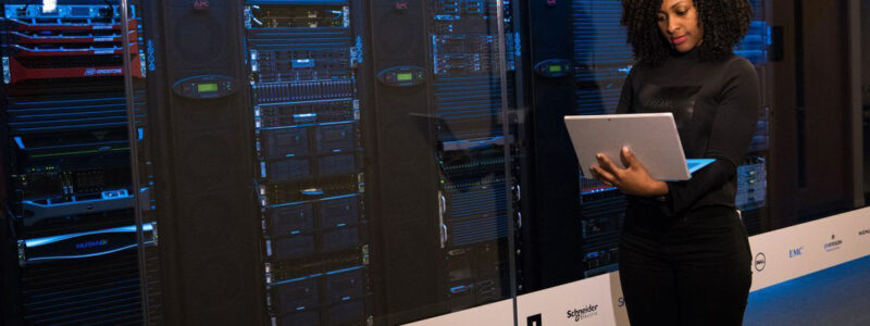 03-protect-server-racks Technology professional working near secure server racks.