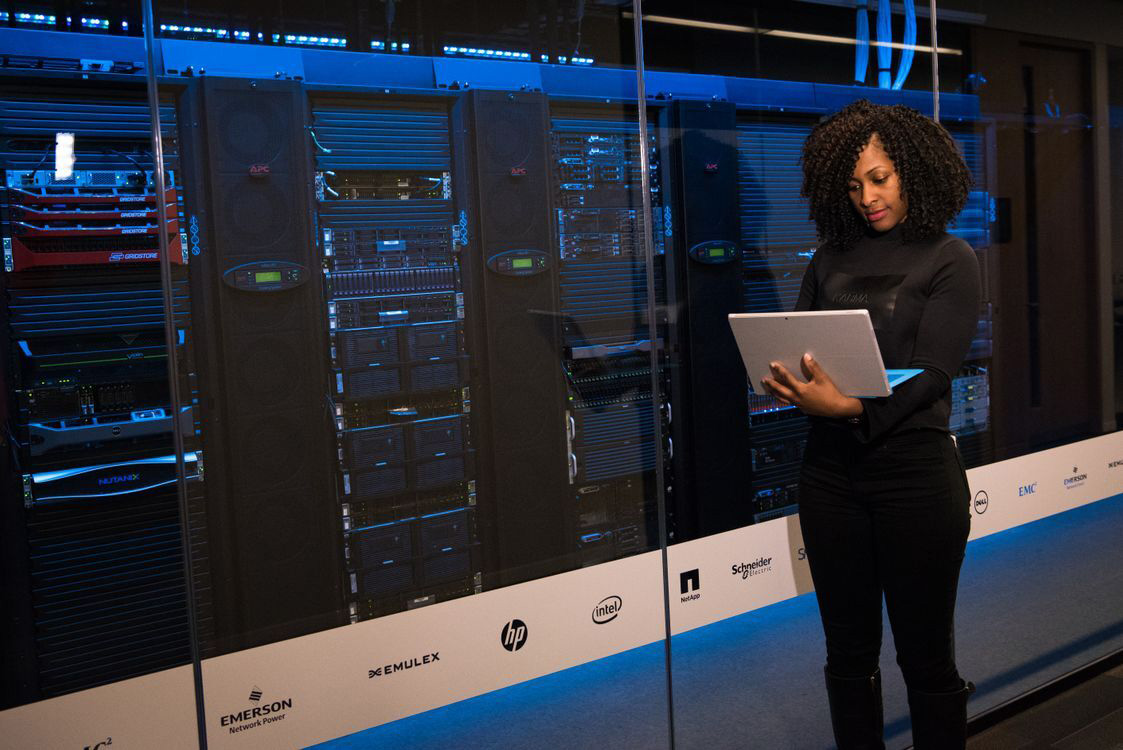 Technology professional working near secure server racks.