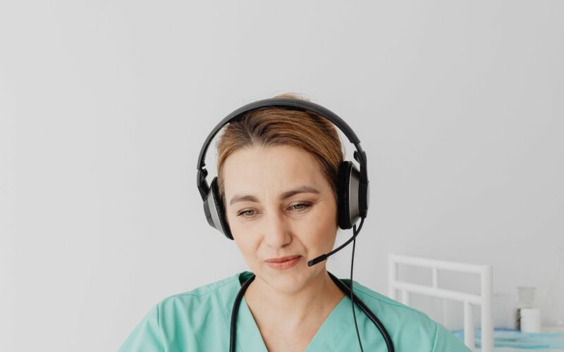 pexels-karola-g-7195420 Healthcare professional using a laptop during a patient conversation.